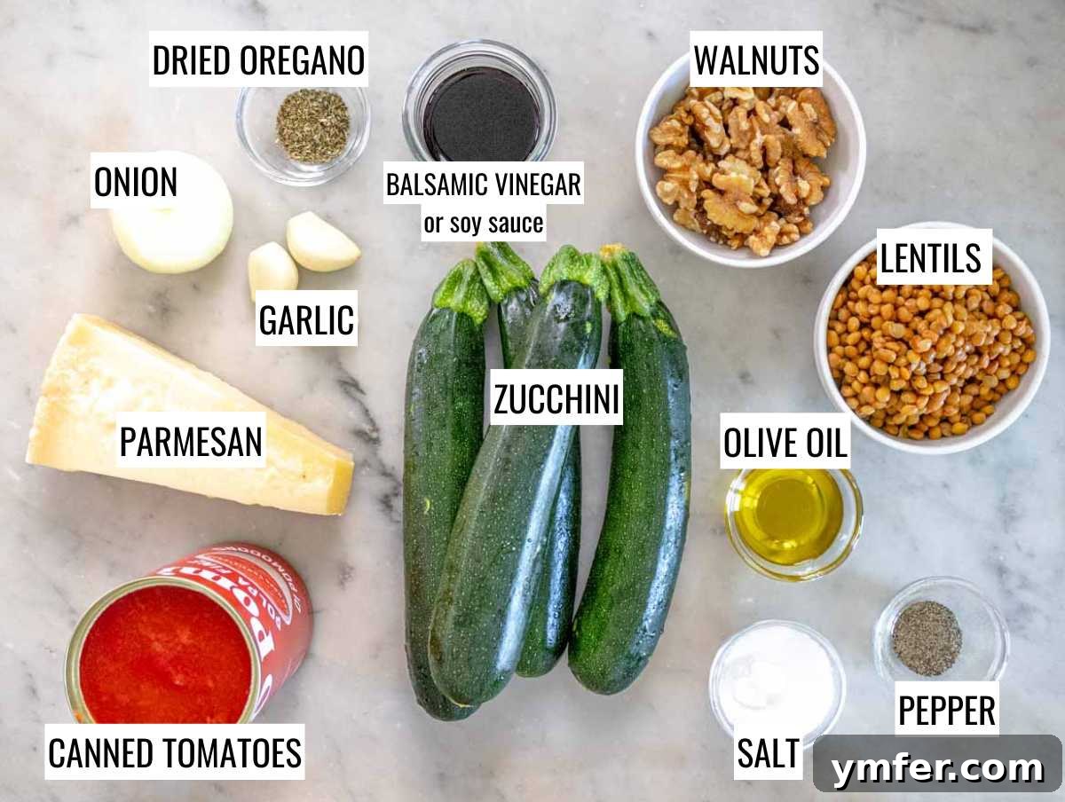 Stuffed Zucchini Canoes 4 A vibrant selection of fresh ingredients laid out for zucchini boats, including zucchini, lentils, tomatoes, walnuts, garlic, onion, and herbs.