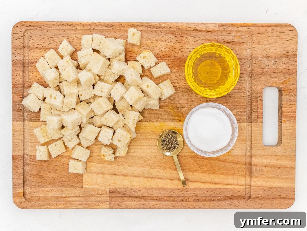 Golden Crunch Air Fryer Croutons 4 ingredients for air fryer croutons. Various ingredients like bread, olive oil, and herbs are laid out.