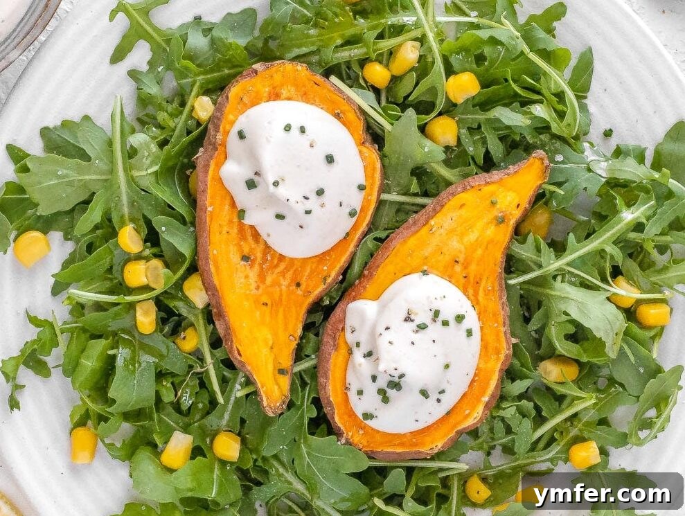 Velvety Vegan Sour Cream 5 A generous dollop of vegan sour cream gracing microwaved sweet potatoes, ready to be enjoyed.