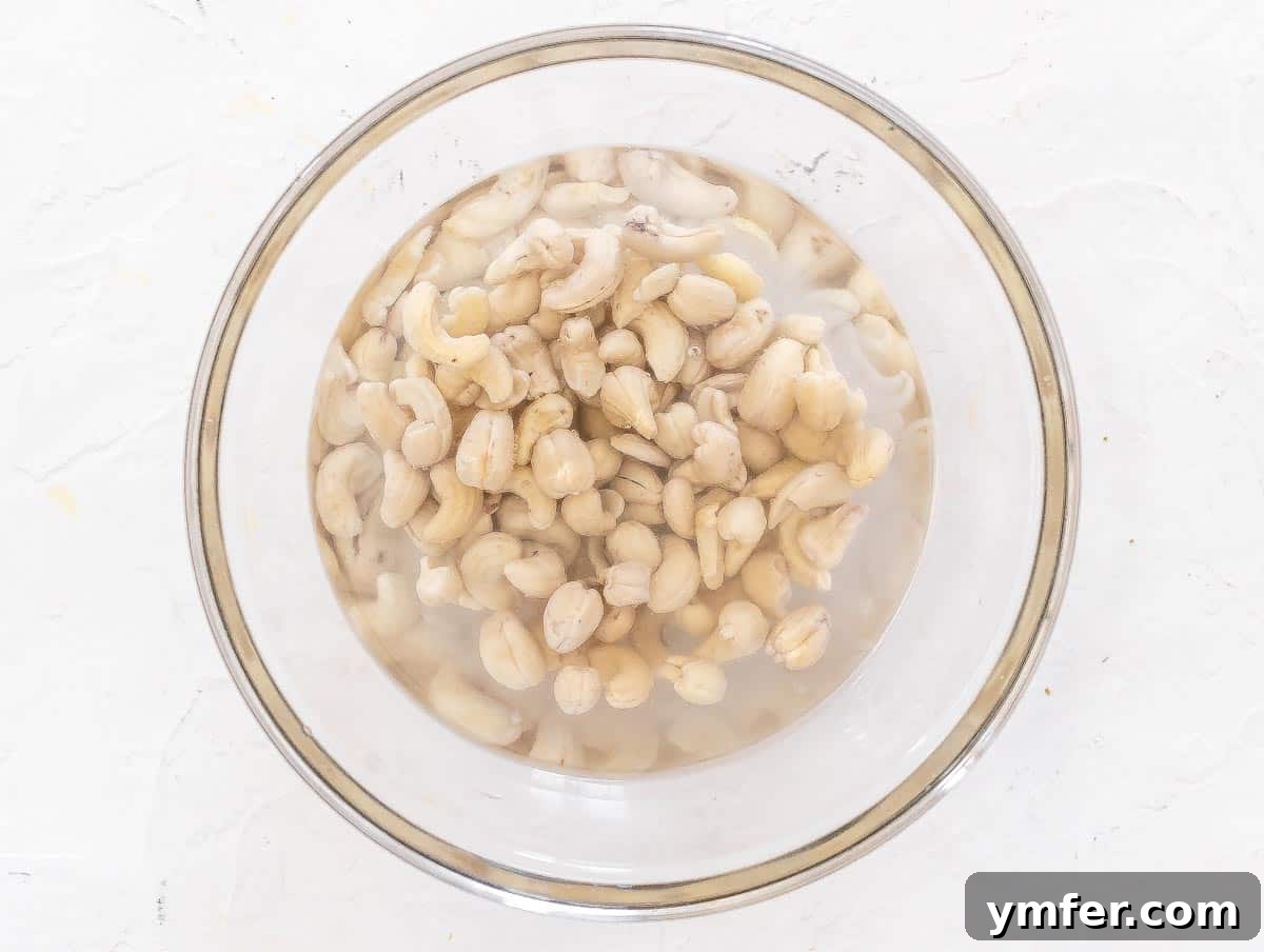 Velvety Vegan Sour Cream 8 Raw cashew nuts soaking in a bowl of hot water.