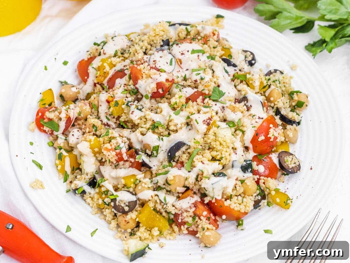 35 Vibrant Vegetarian Lunch Ideas 10 A flavorful couscous salad topped with a rich tahini dressing.