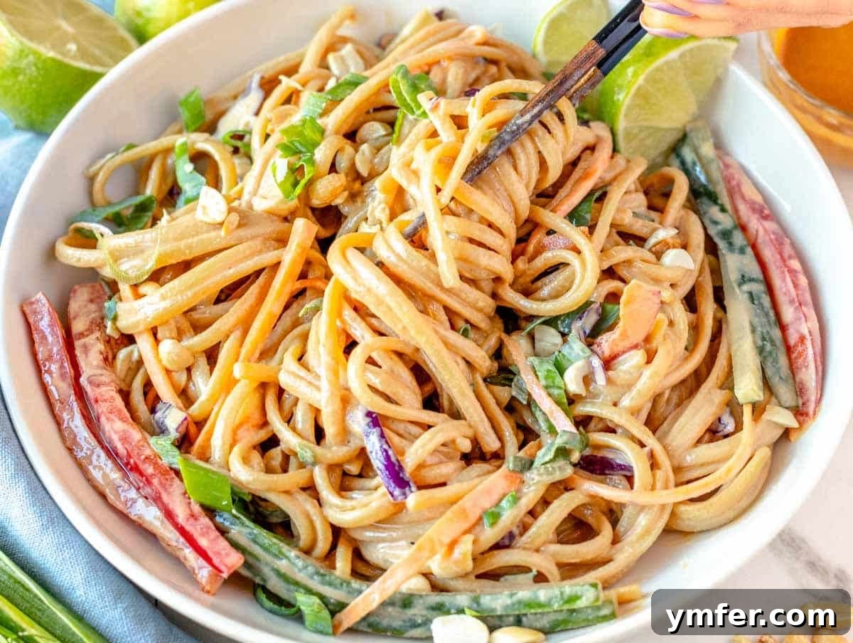 35 Vibrant Vegetarian Lunch Ideas 19 Peanut noodles garnished with fresh vegetables, served with chopsticks.