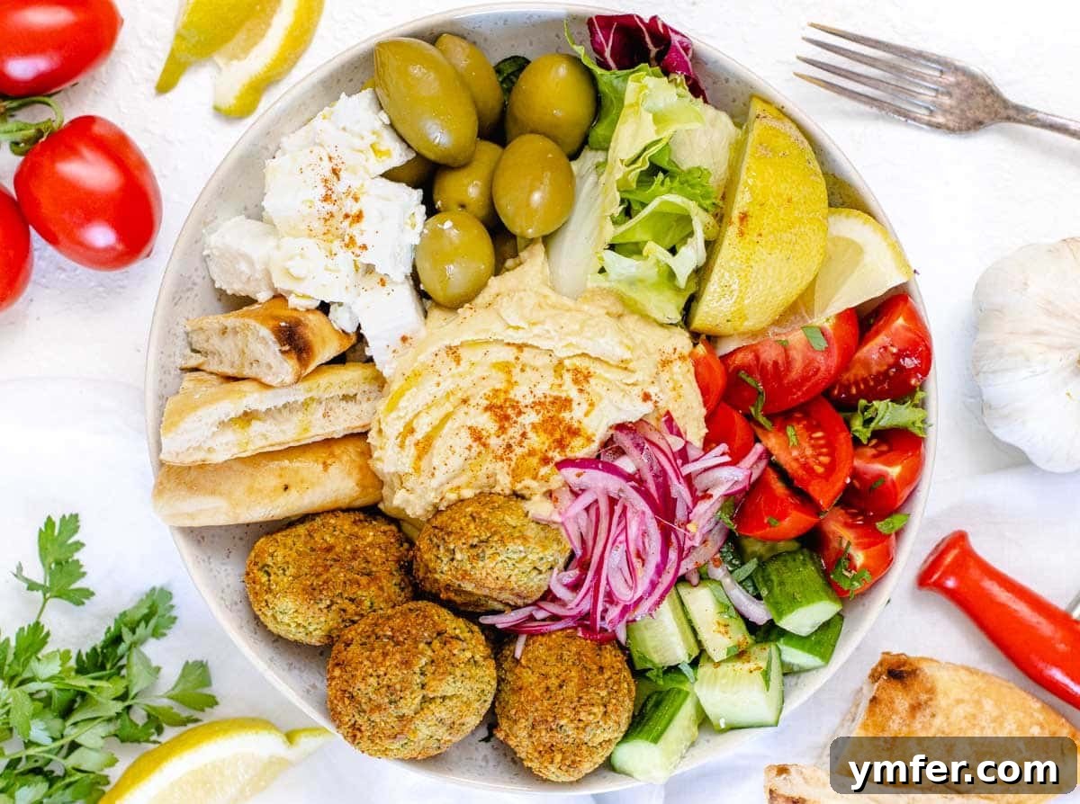 35 Vibrant Vegetarian Lunch Ideas 30 A colorful Mediterranean bowl garnished with fresh parsley.