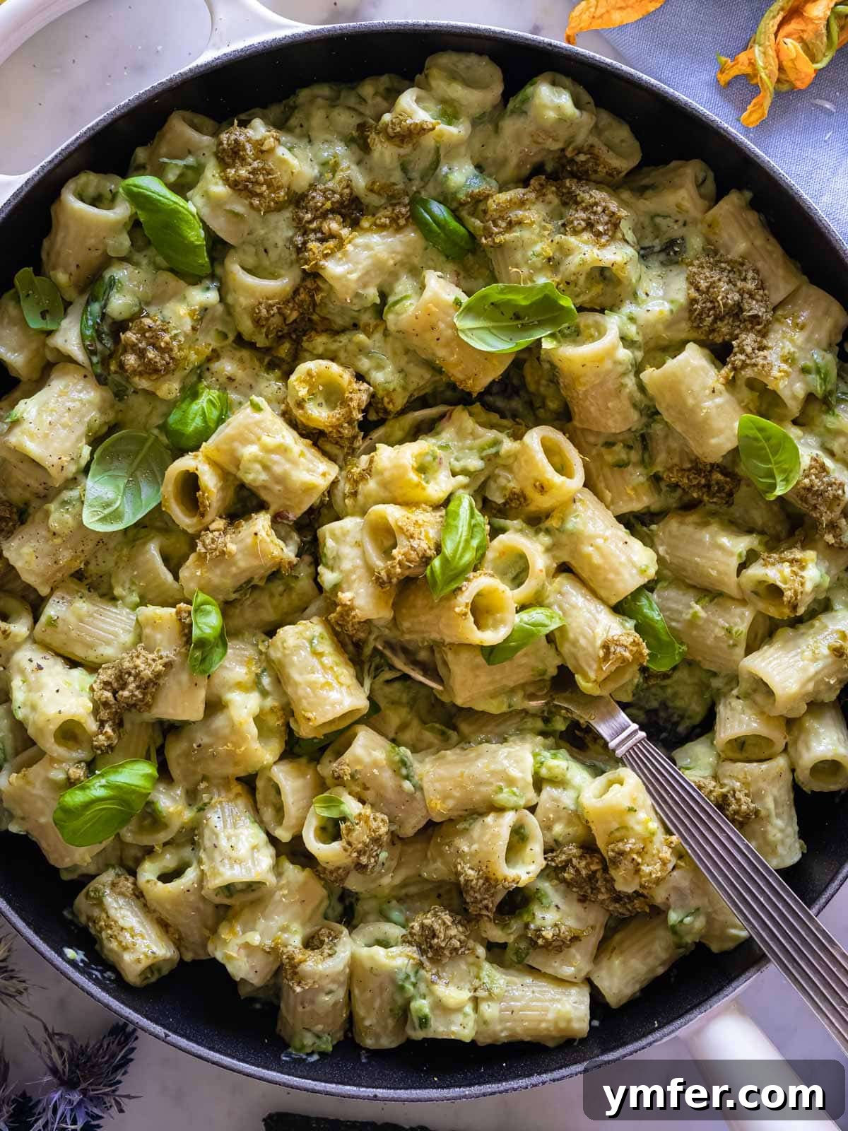 Spiralized Zucchini Delight 2 Creamy Zucchini pasta served in a bowl, garnished with fresh herbs and cheese.