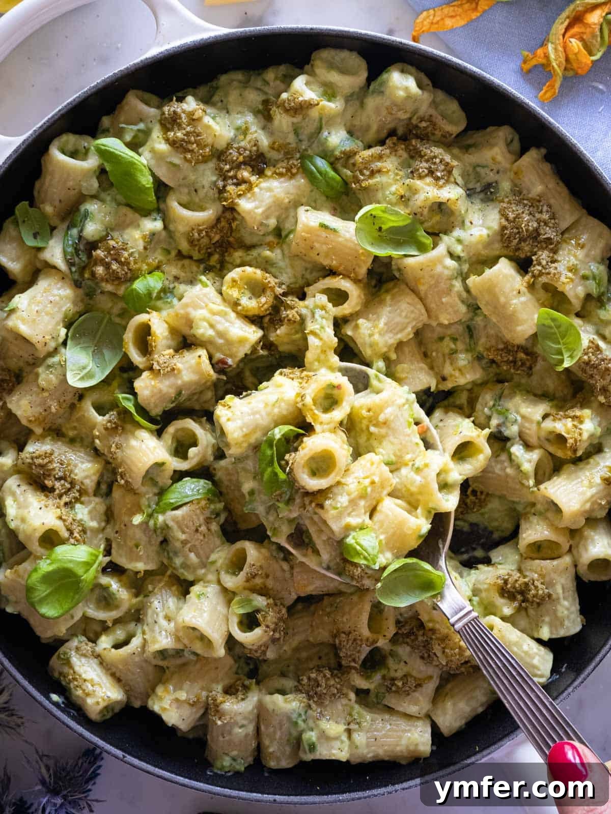 Spiralized Zucchini Delight 4 Creamy zucchini pasta simmering in a cast-iron skillet, ready to be served.