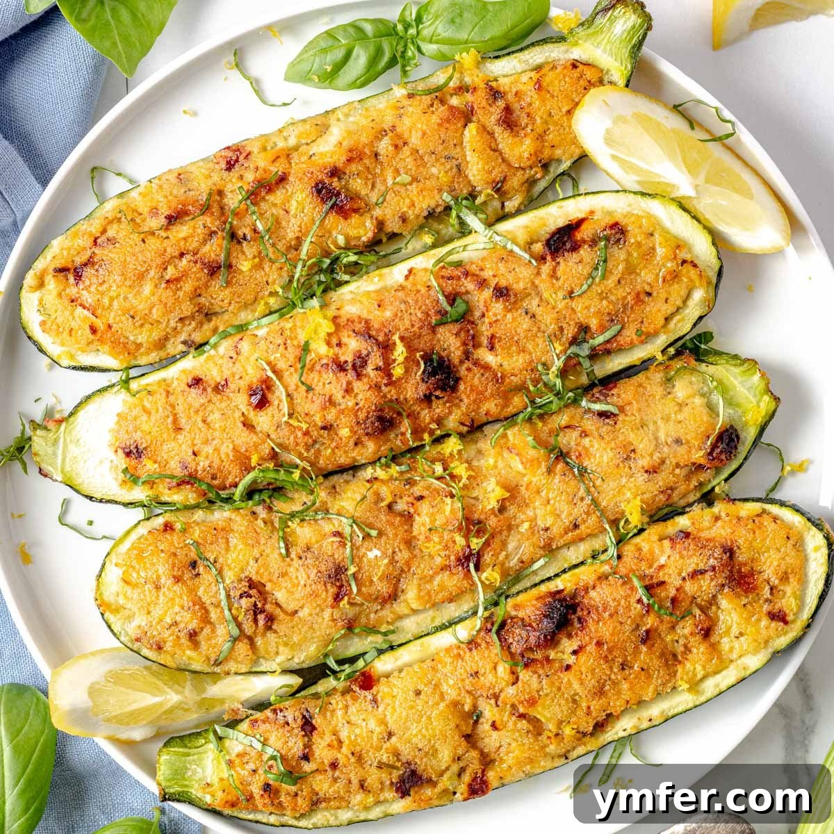 Stuffed zucchini halves topped with parsley.