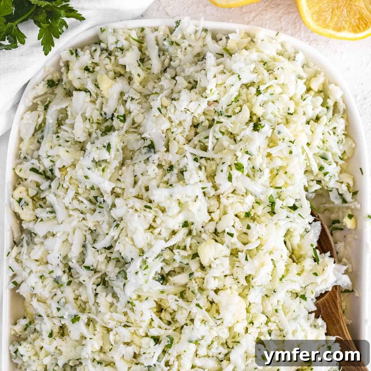 Cauliflower rice with fresh parsley in a bowl.