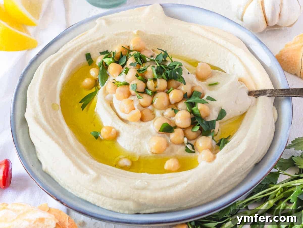 Perfect Pairings for Hummus 3 Hummus on a plate with a silver spoon.