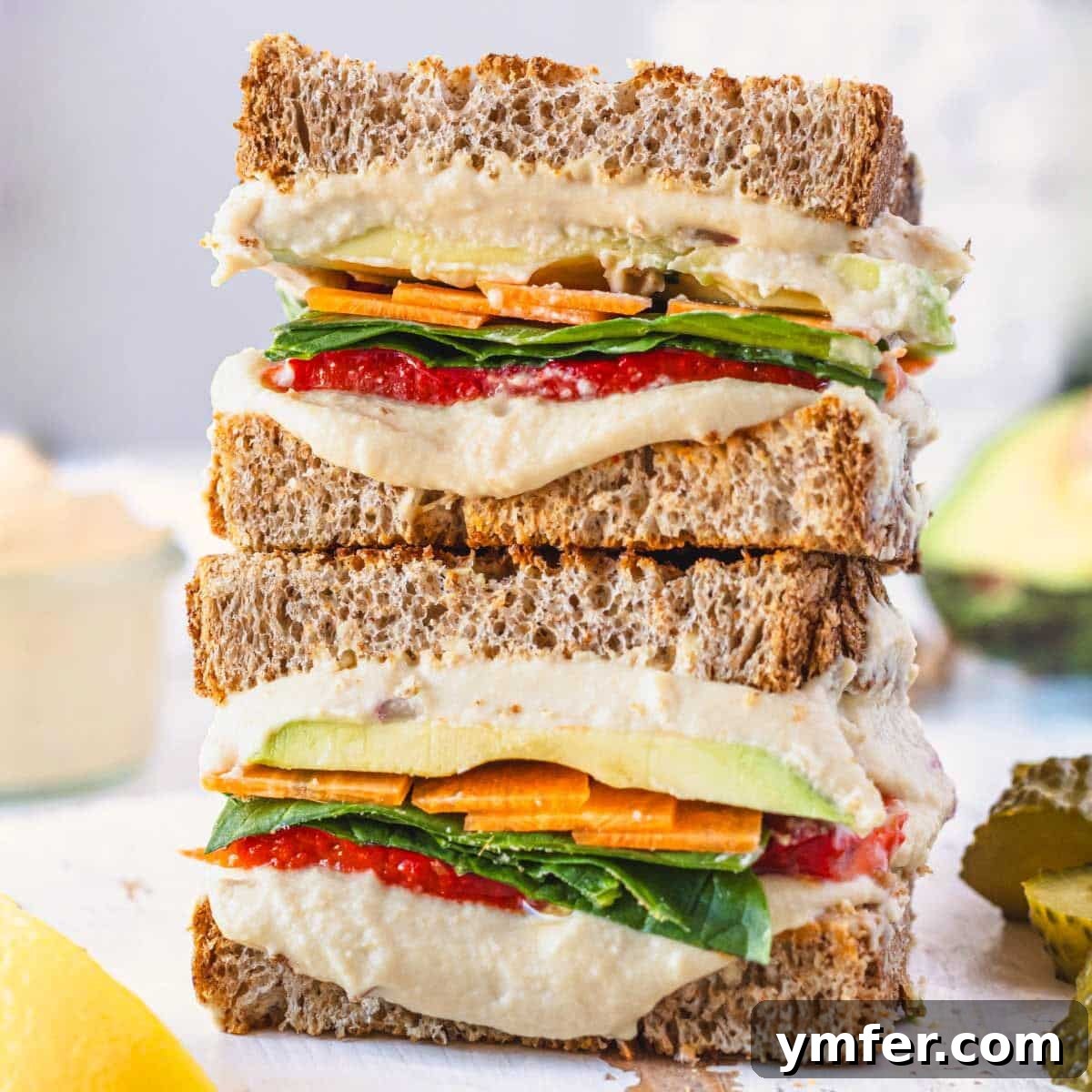 Hummus sandwich with fresh vegetables and avocado.