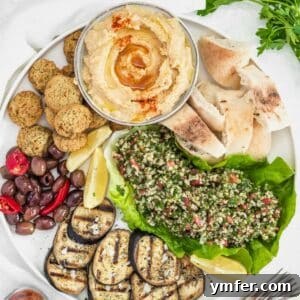 Hummus, falafel, tabbouleh, and grilled eggplant on a plate.
