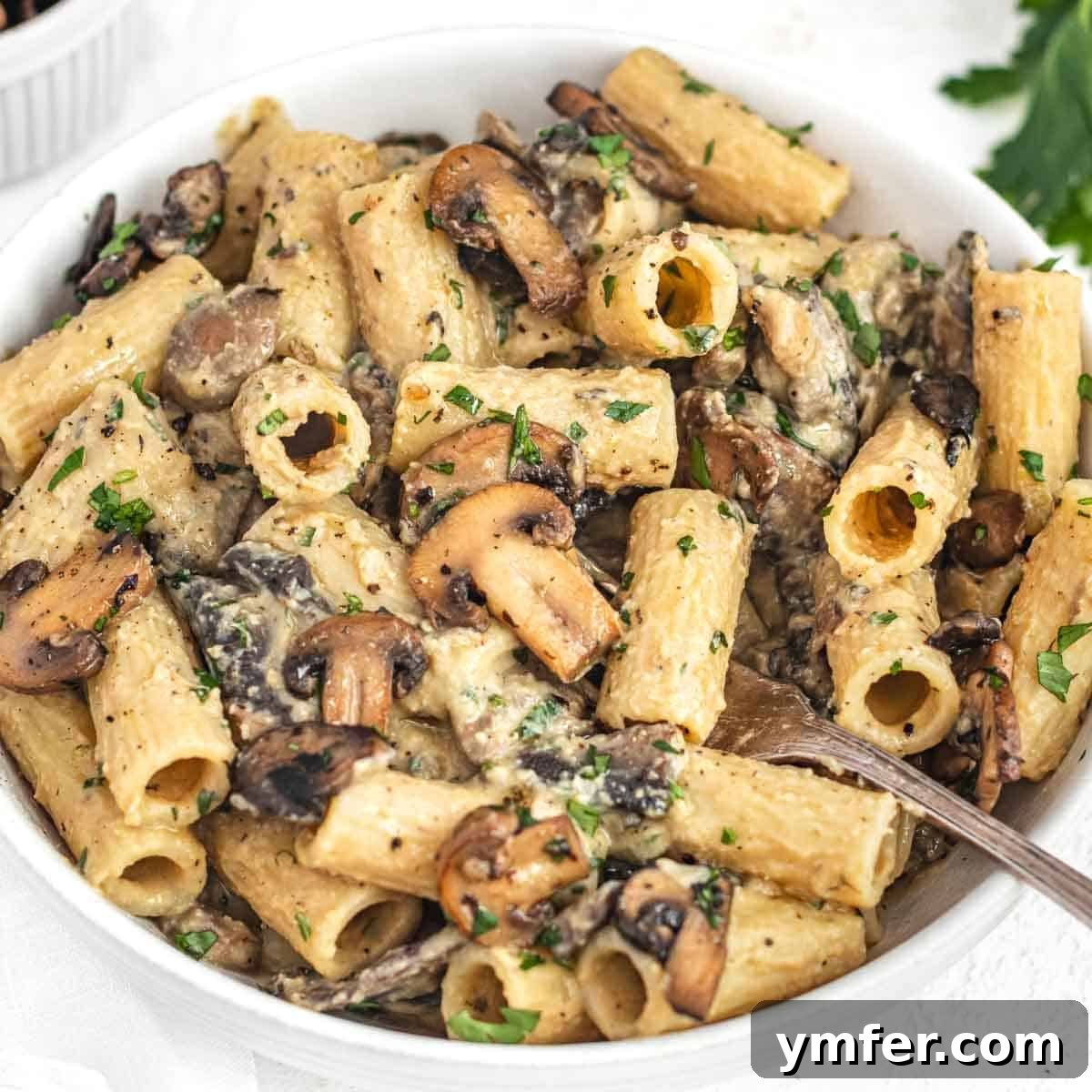 Hummus pasta topped with sautéed mushrooms.