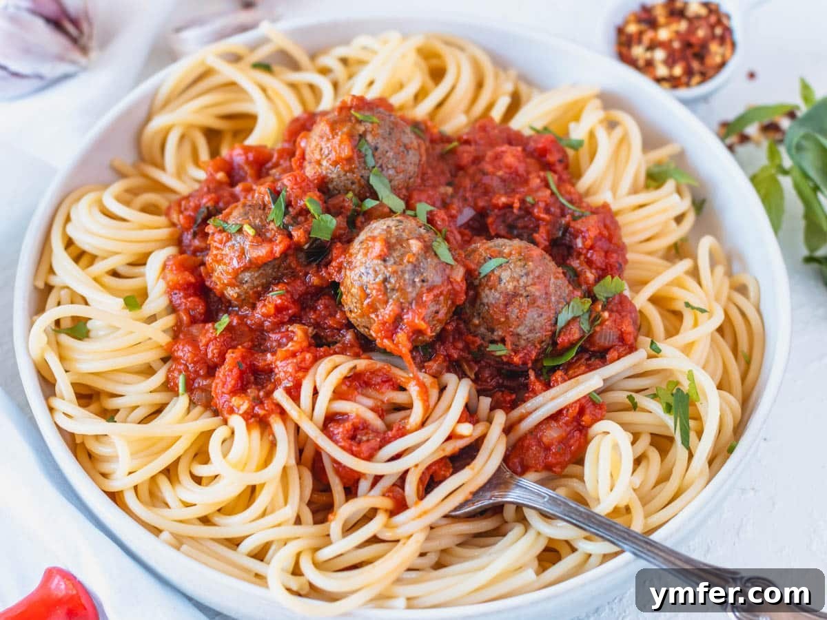 Rustic Marinara 15 Vegan meatballs on spaghetti with a silver fork