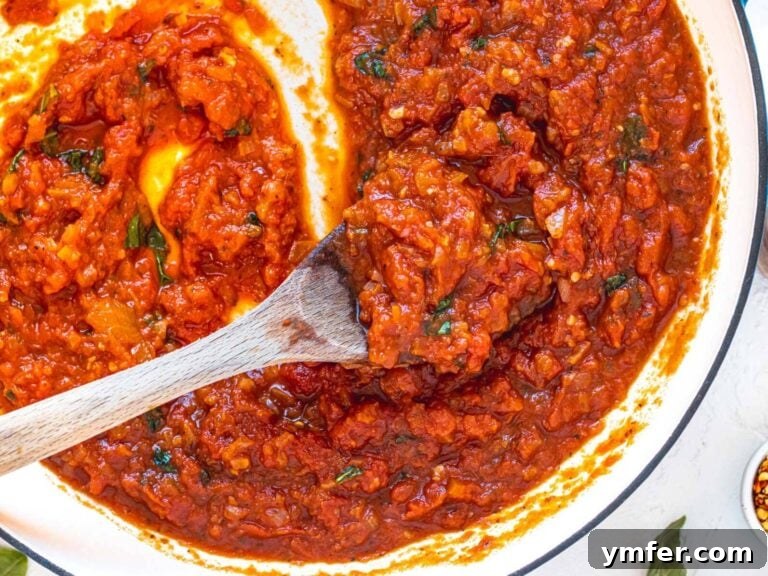 Rustic Marinara 24 Marinara sauce in a skillet with a wooden spoon