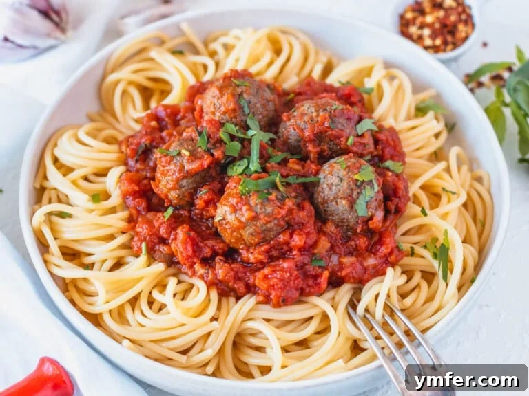 Rustic Marinara 25 tofu meatballs with marinara sauce and spaghetti in a bowl
