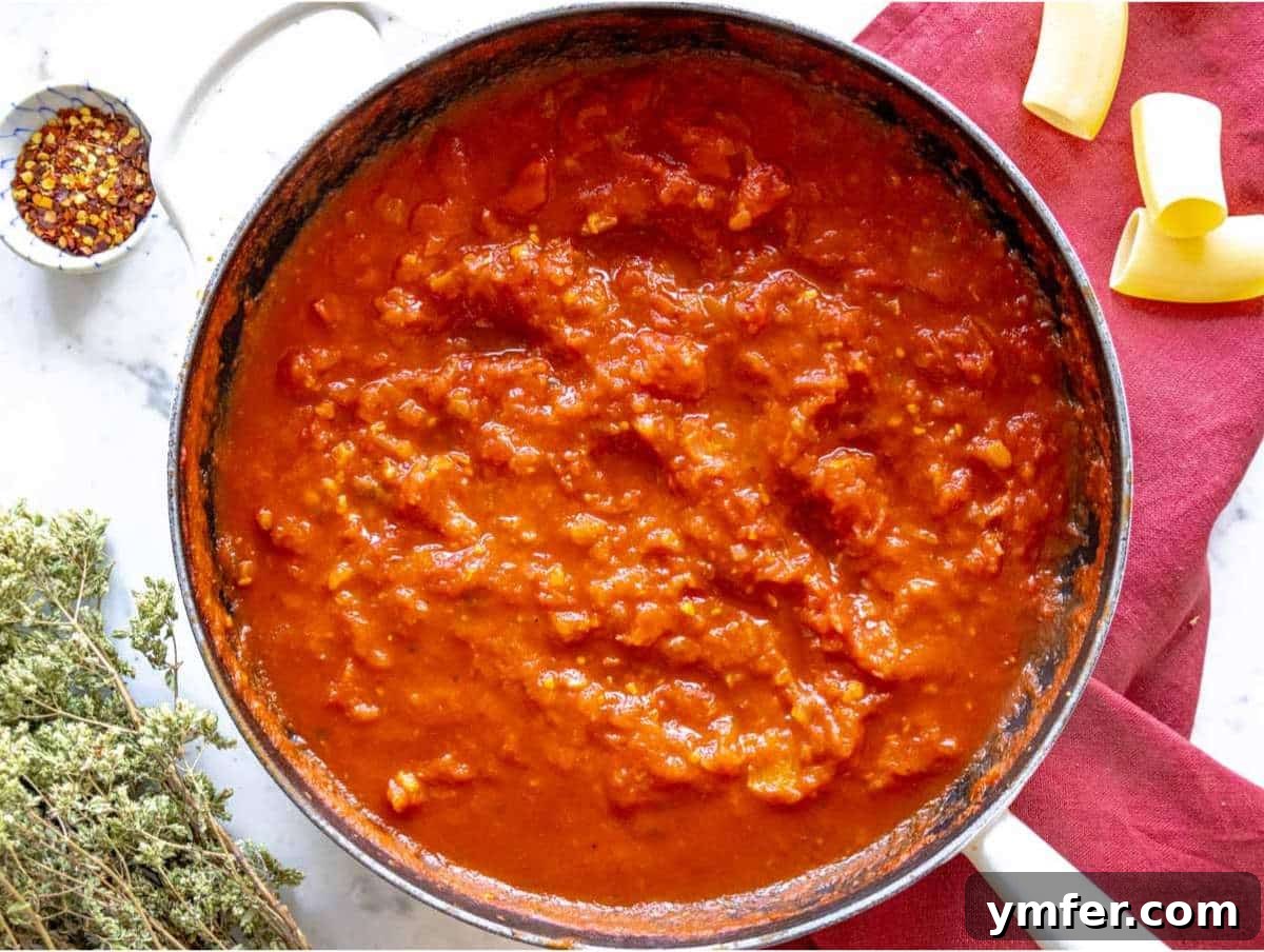 Sicilian Eggplant Pasta Delight 6 Step 2 Onion garlic and tomatoes simmering in pan for pasta alla Norma sauce.