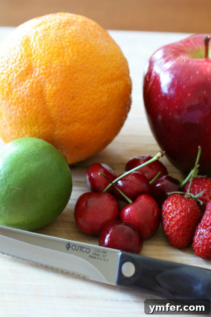 Close-up of a glass of red wine sangria with ice, fresh fruit slices, and a vibrant red hue, showcasing the refreshing drink.