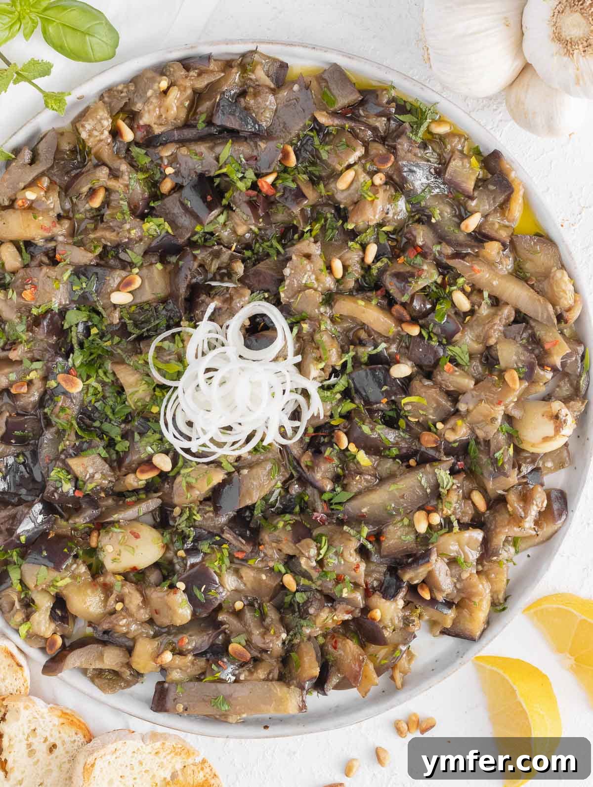 Sweet and Tangy Glazed Eggplant 2 A delicious bowl of sweet and sour eggplant garnished with fresh herbs.