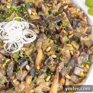 Sweet and sour eggplant, beautifully plated and garnished.