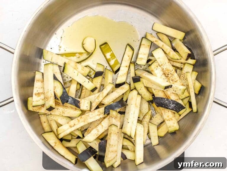 Sweet and Tangy Glazed Eggplant 13 Eggplant cooking in a skillet with garlic and olive oil.
