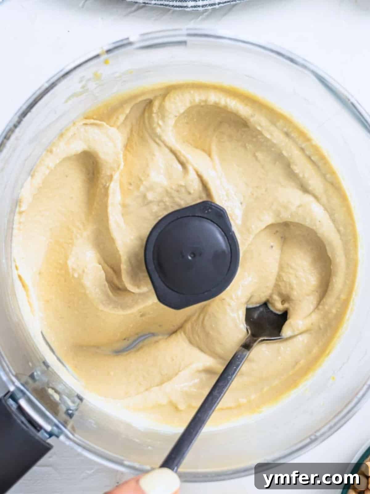 The Art of Hummus 4 A close-up of a bowl of perfectly smooth and creamy hummus, ready to be served.