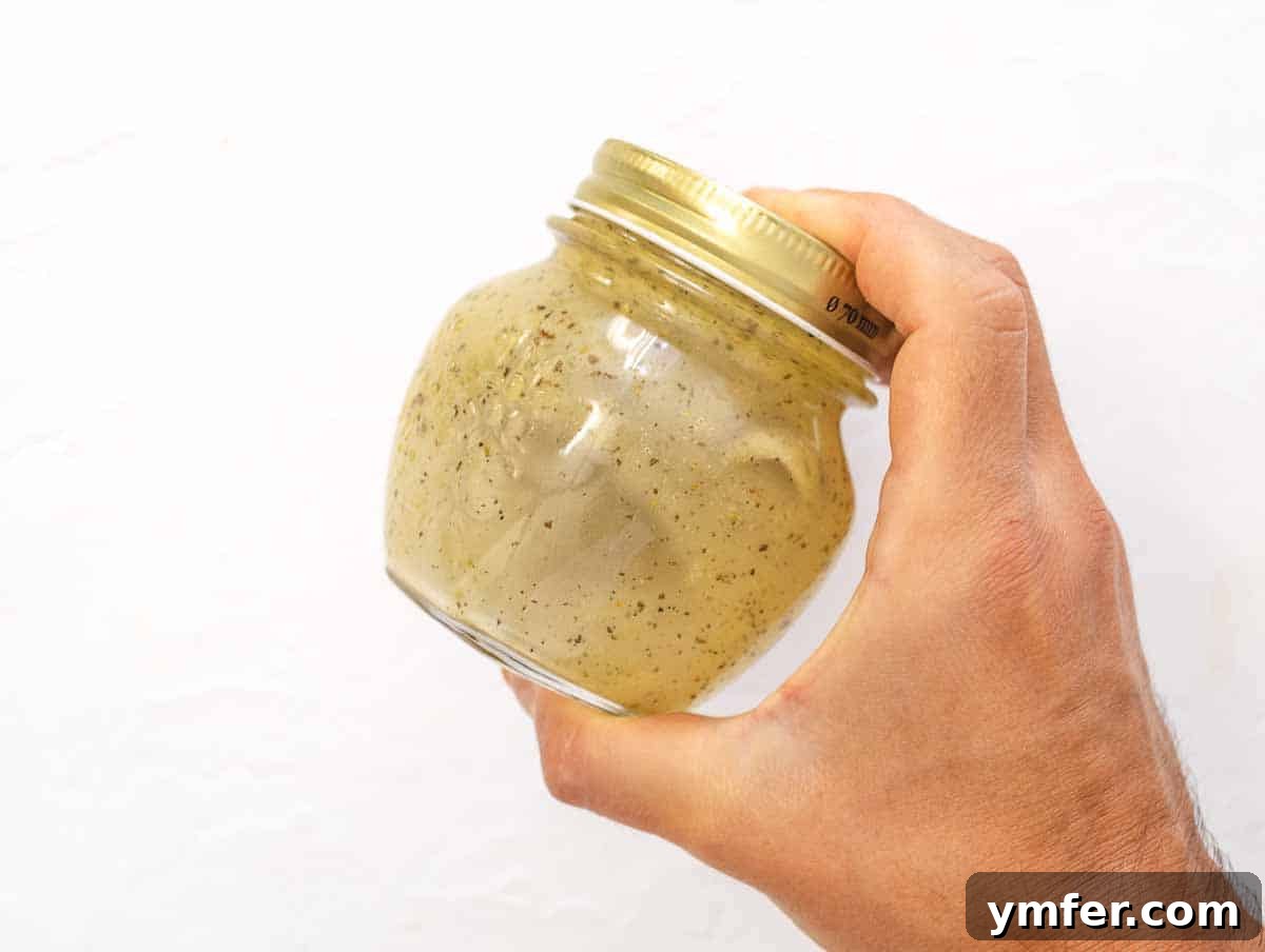 Ingredients for Italian dressing being combined in a mason jar