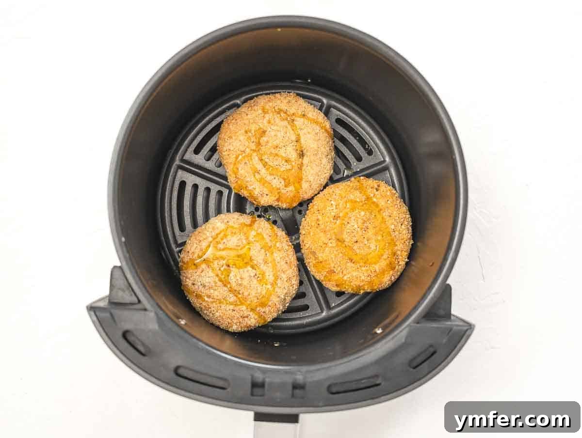 Arancini 12 Risotto cakes neatly arranged in an air fryer basket, ready for cooking.
