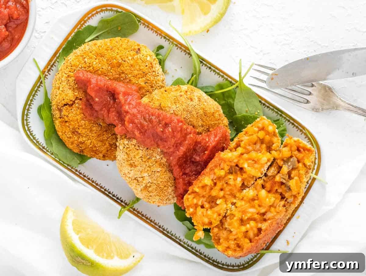 Arancini 14 Oven-baked risotto cakes arranged on a baking sheet.