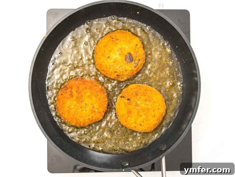 Arancini 19 tomato and eggplant risotto cakes shallow frying in a pan