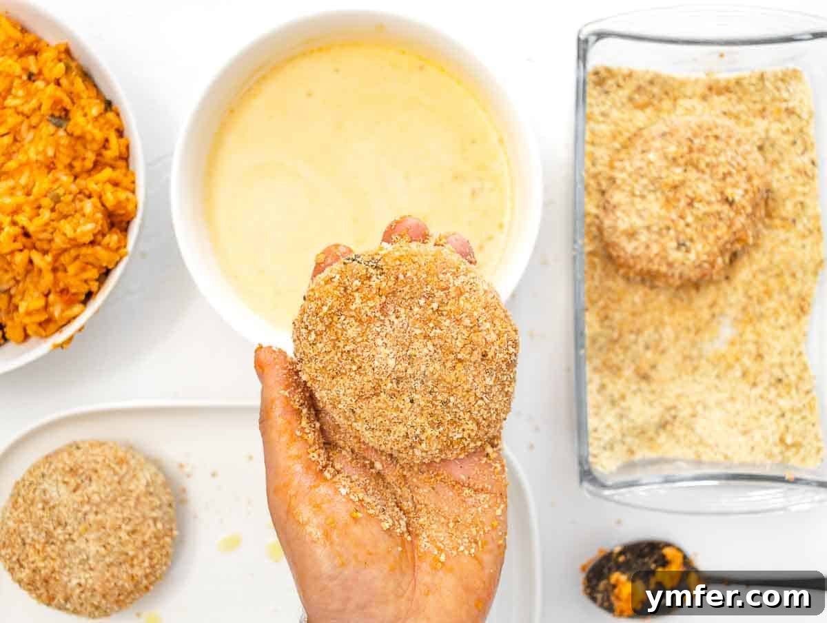 Arancini 7 Hands carefully shaping a risotto cake, pressing it firmly to create a compact patty.