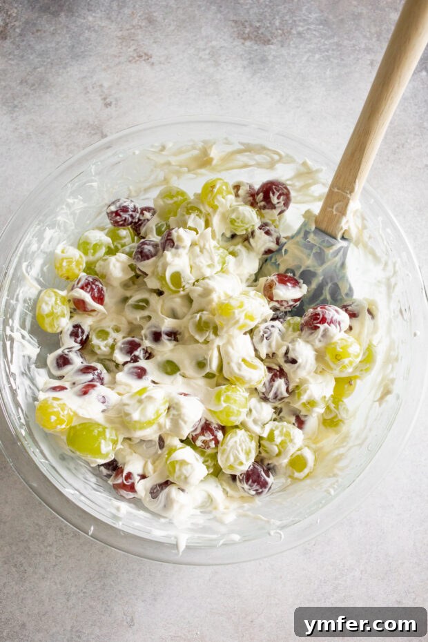 Luscious Grape Medley 4 Grapes mixed with marshmallow fluff and cream cheese in a bowl.