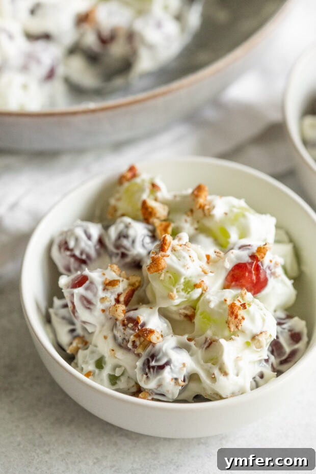Luscious Grape Medley 6 Creamy and sweet grape salad in a bowl topped with chopped pecans.