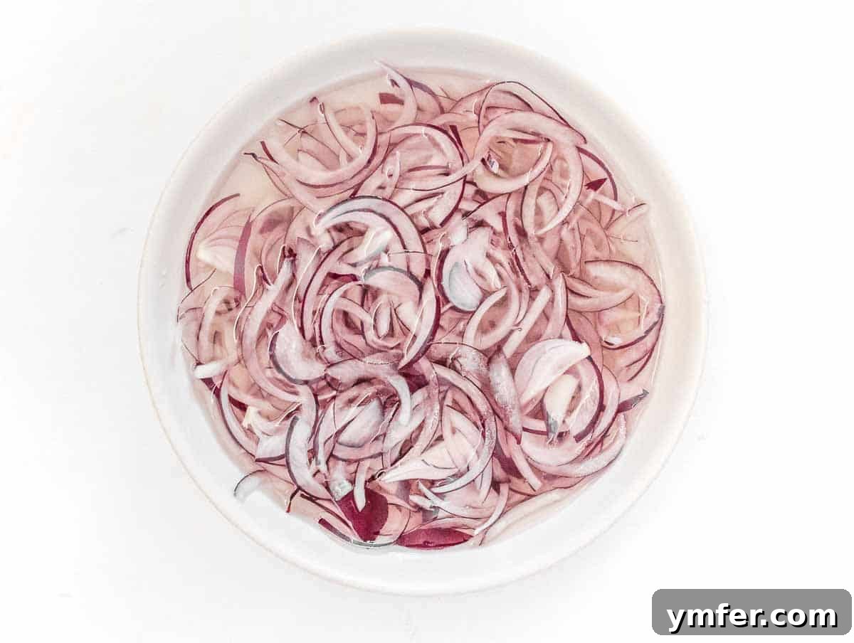 Fresh Avocado Bliss 5 Sliced red onion soaking in cold water to reduce its pungency.