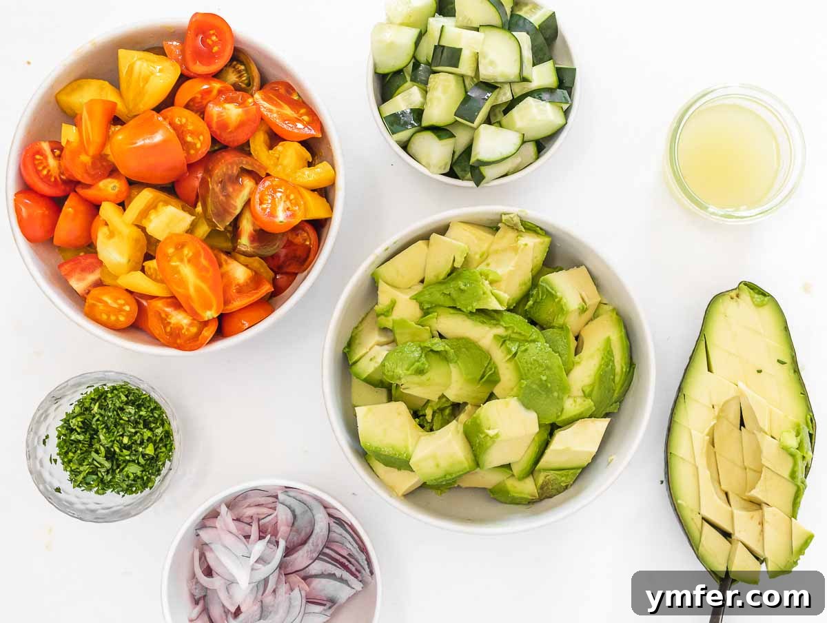 Fresh Avocado Bliss 6 All the chopped vegetables, including avocado, tomatoes, cucumber, and parsley, ready for the salad.