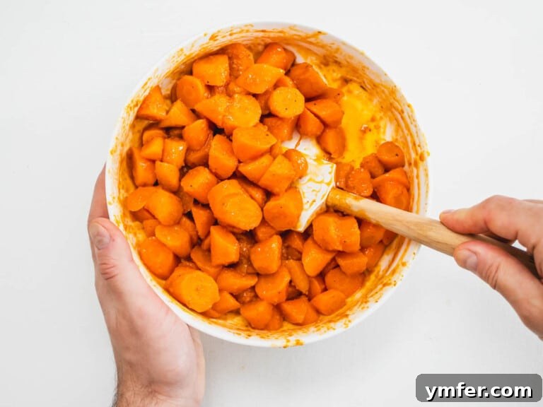 Moroccan Spiced Carrot Salad 8 hands mixing carrots with a harissa dressing