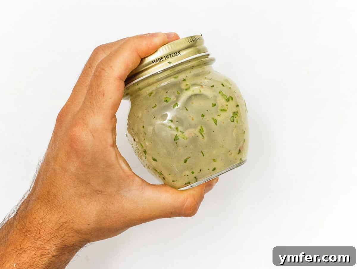 Sweet Carrot and Raisin Slaw 11 Homemade orange dressing in a jar, ready to be shaken.