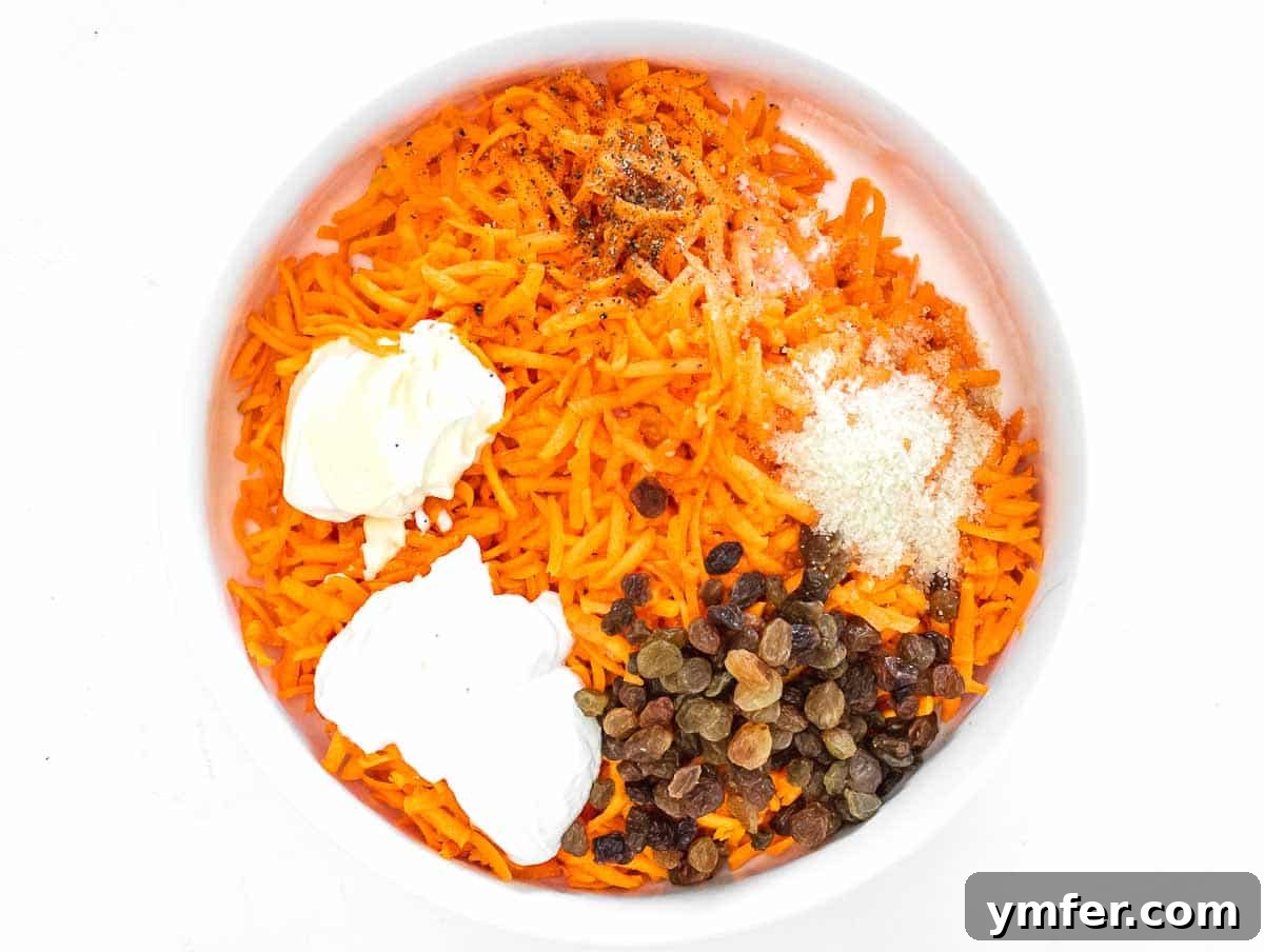 Sweet Carrot and Raisin Slaw 7 All ingredients being added to the bowl for grandma's carrot raisin salad before mixing.