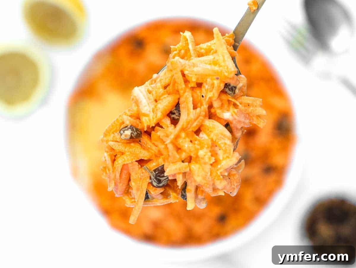 Sweet Carrot and Raisin Slaw 8 Creamy carrot raisin salad after mixing, showing a uniform coating of dressing.