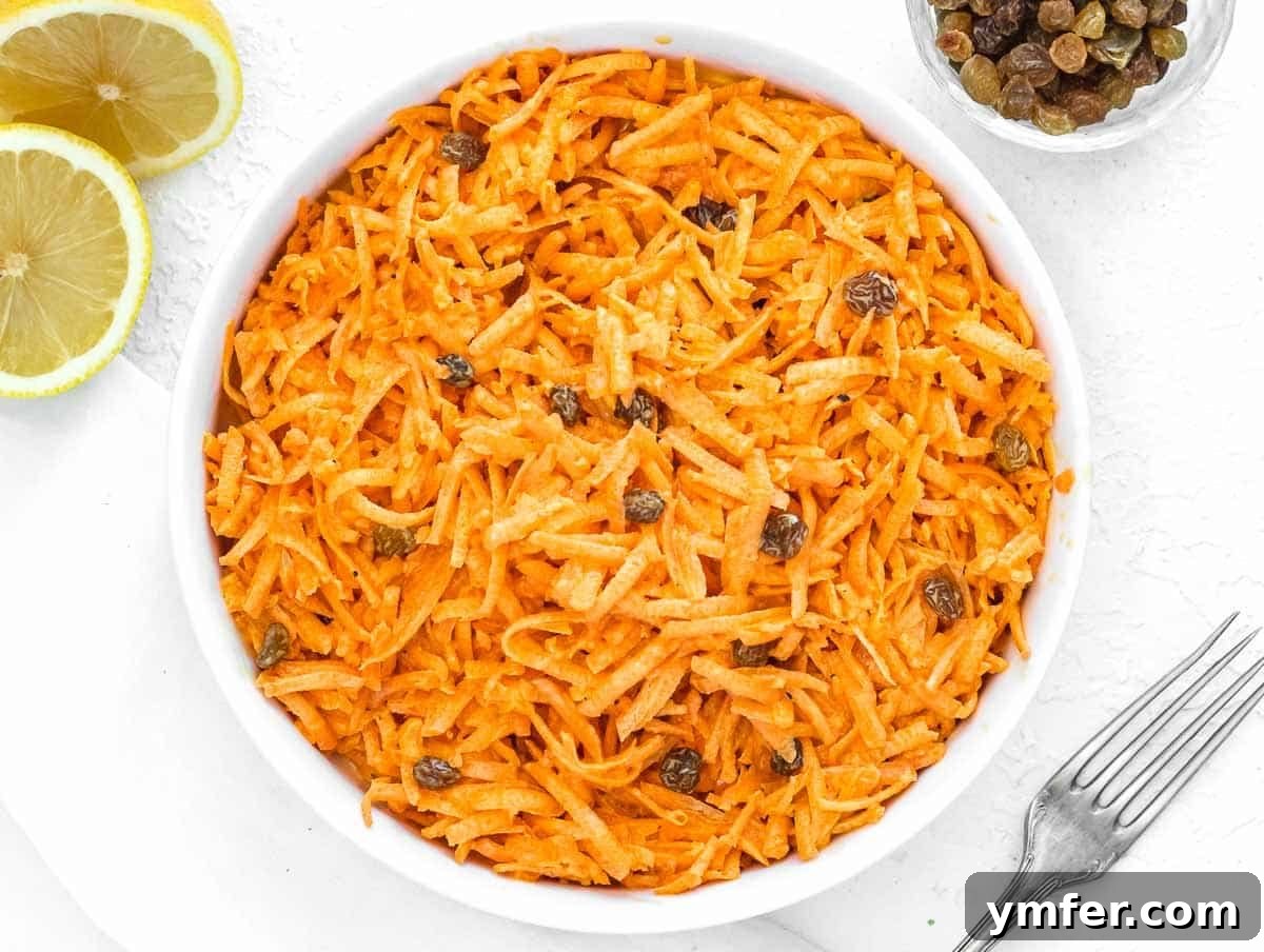 Sweet Carrot and Raisin Slaw 9 Plated carrot raisin salad with mayonnaise, ready to be served.