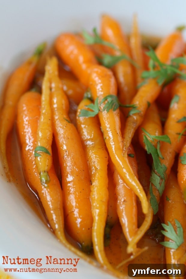 Exquisite Vanilla Maple Glazed Carrots 4 A selection of raw carrots on a cutting board, highlighting the fresh, natural ingredient that forms the basis of this delicious glazed carrot recipe.