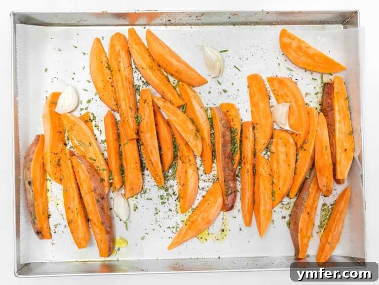 seasoning sweet potato wedges with rosemary, oil, and salt
