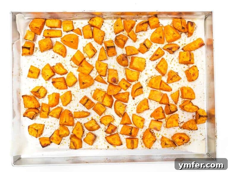 Golden Roasted Sweet Potatoes 16 roasted sweet potato cubes on a baking sheet