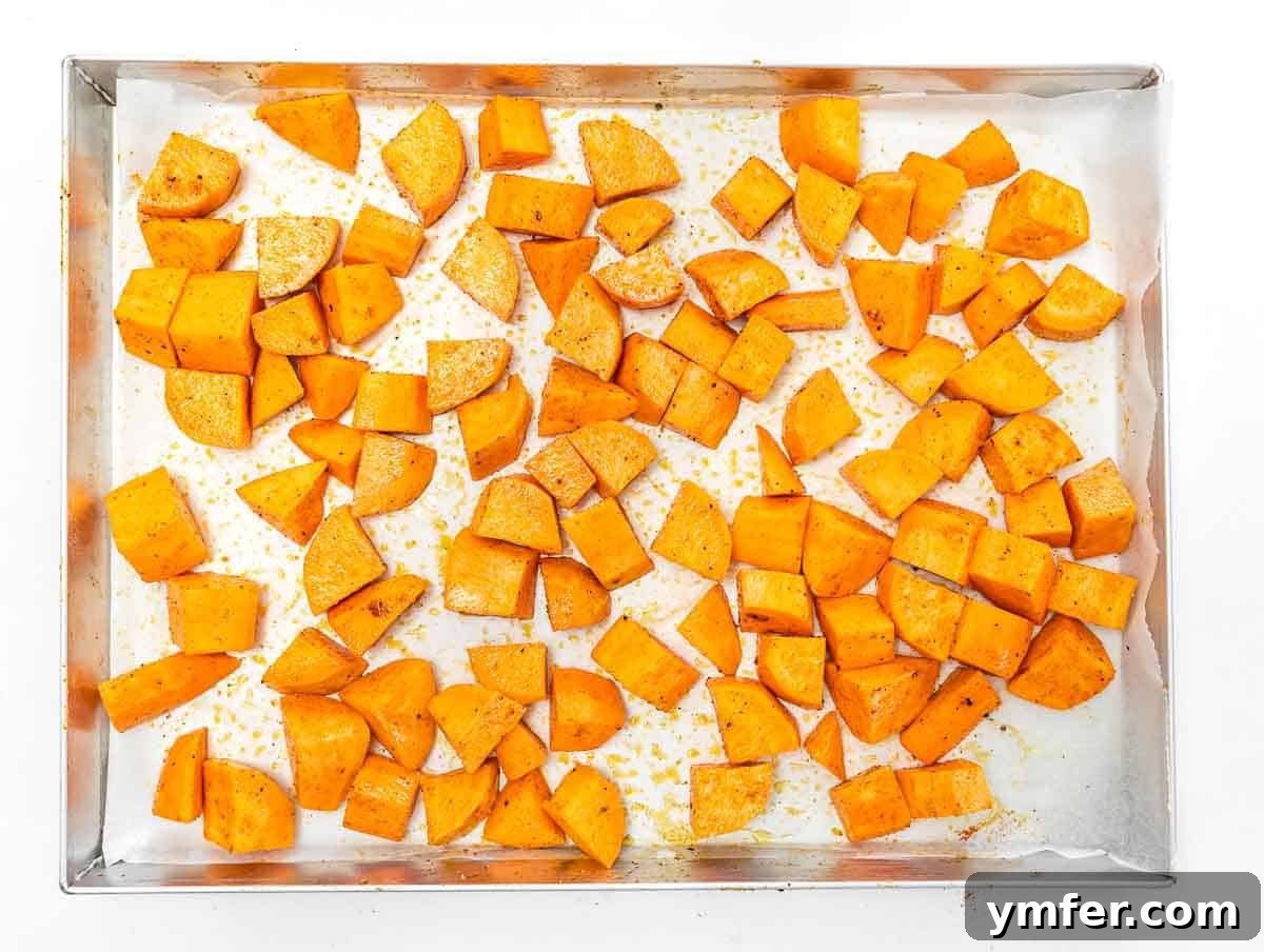 Golden Roasted Sweet Potatoes 7 sweet potato dice on a baking sheet with olive oil, salt, and pepper