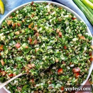 Healthy tabouli (tabbouleh) recipe served as a Mediterranean salad with pita bread and fresh herbs, perfect for plant-based eating, emphasizing its vibrant appeal and health benefits.
