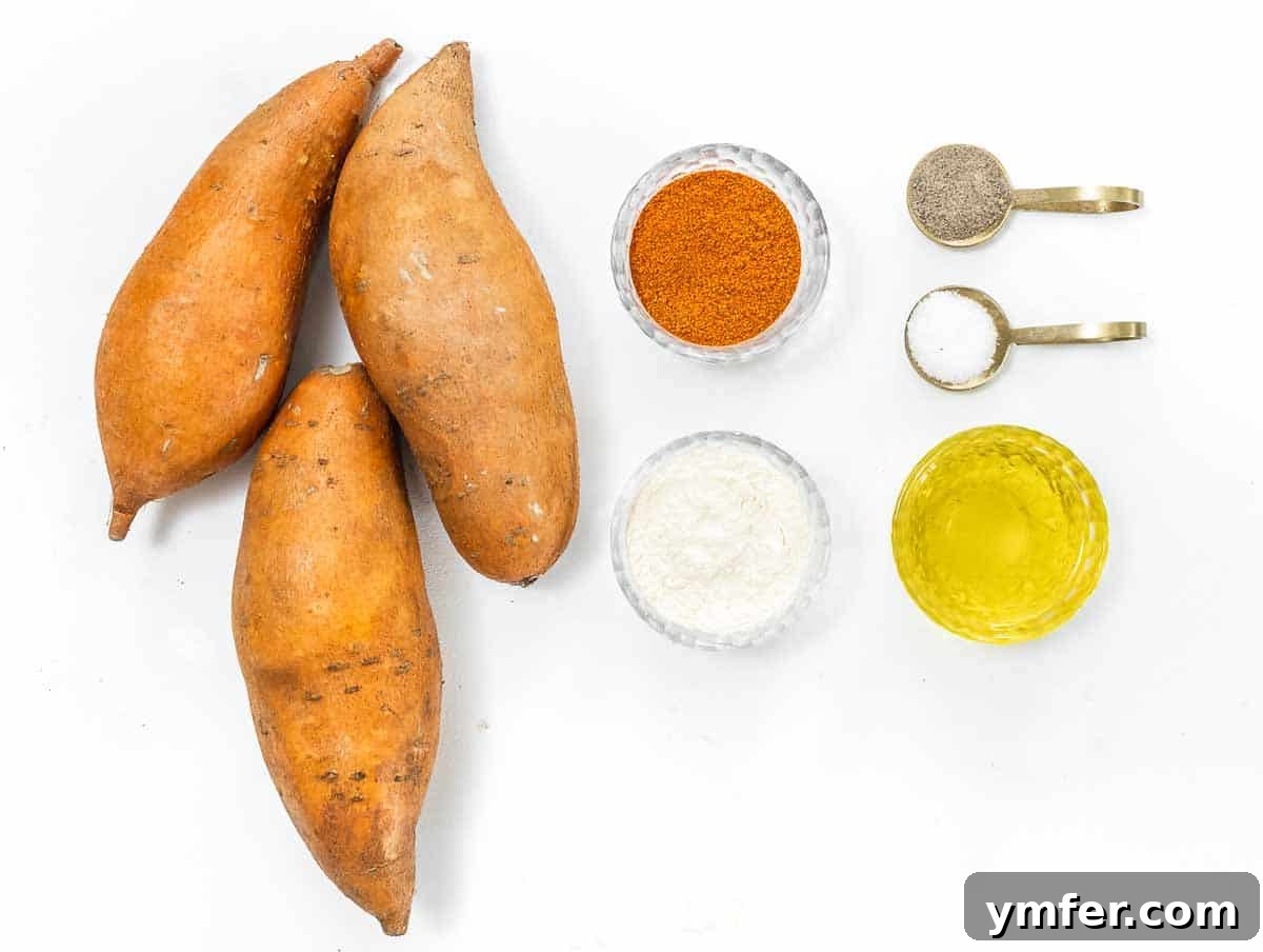 Golden & Crispy Air Fryer Sweet Potatoes 3 Ingredients laid out for making air fryer sweet potato cubes: sweet potatoes, olive oil, and spices.
