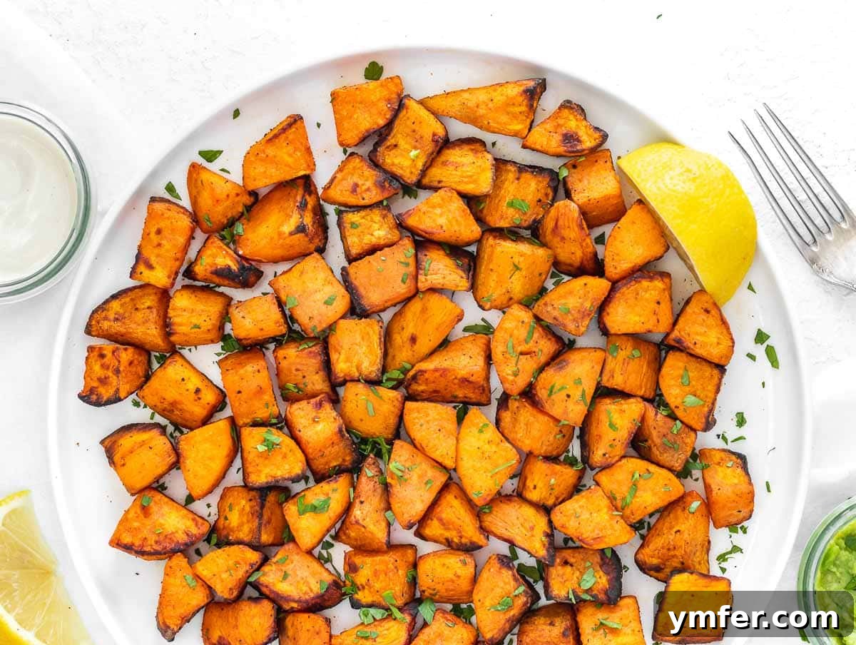 Golden & Crispy Air Fryer Sweet Potatoes 4 Close-up of seasoned air fryer sweet potato cubes, glistening with oil and spices.
