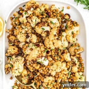 Lentil cauliflower salad with fresh parsley on a white platter