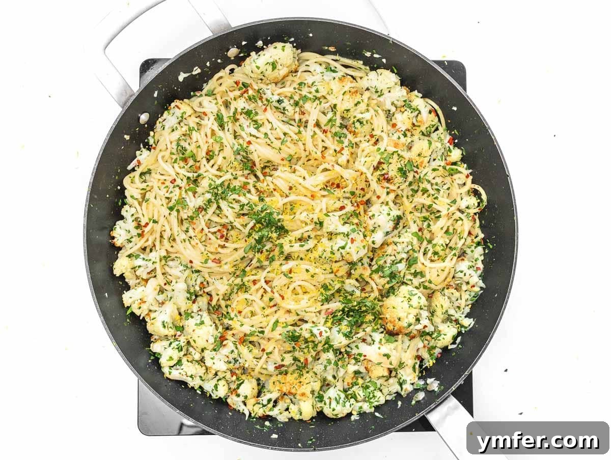 Velvety Cauliflower Pasta 10 Cooked pasta added to a pan with roasted cauliflower and sauce.
