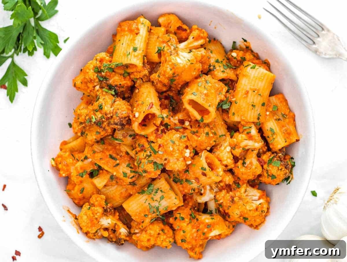 Velvety Cauliflower Pasta 13 Red pepper pasta with roasted cauliflower served in a large bowl.