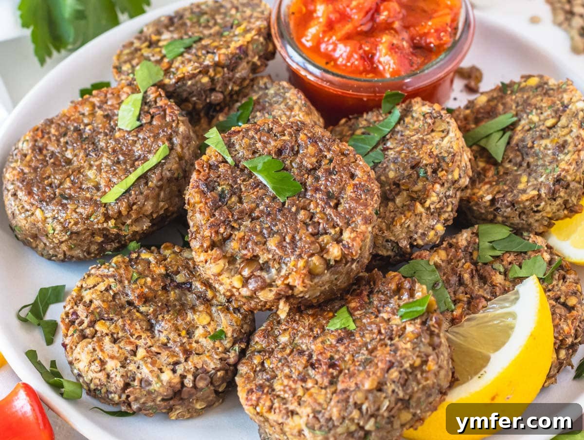 Hearty Lentil Harvest 30 Wholesome Recipes 24 Golden-brown lentil patties served with lemon wedges and fresh parsley.