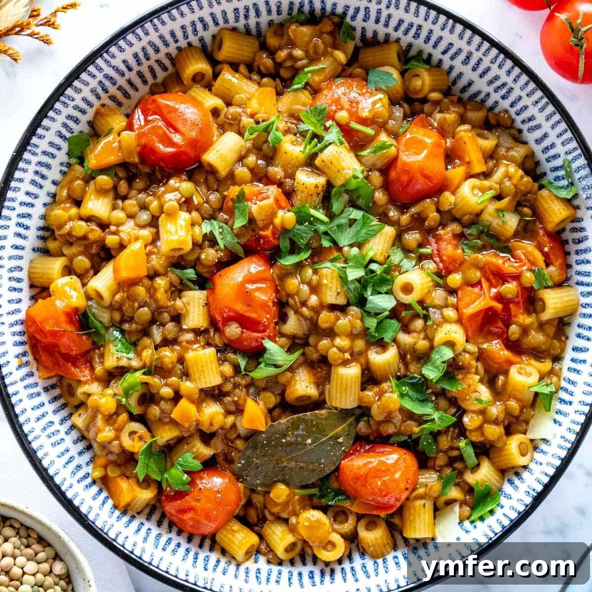 Hearty Lentil Harvest 30 Wholesome Recipes 6 A serving of comforting lentil pasta in a white bowl, ready to enjoy.